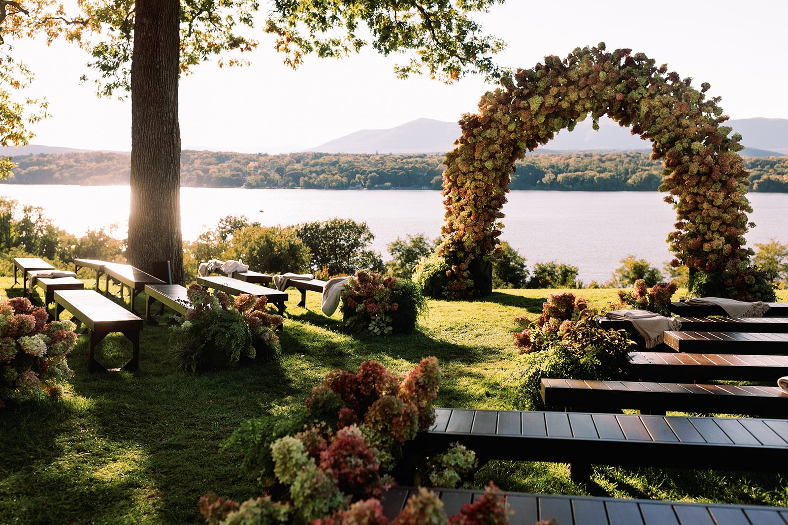 Waterfront floral arch for an outdoor wedding ceremony