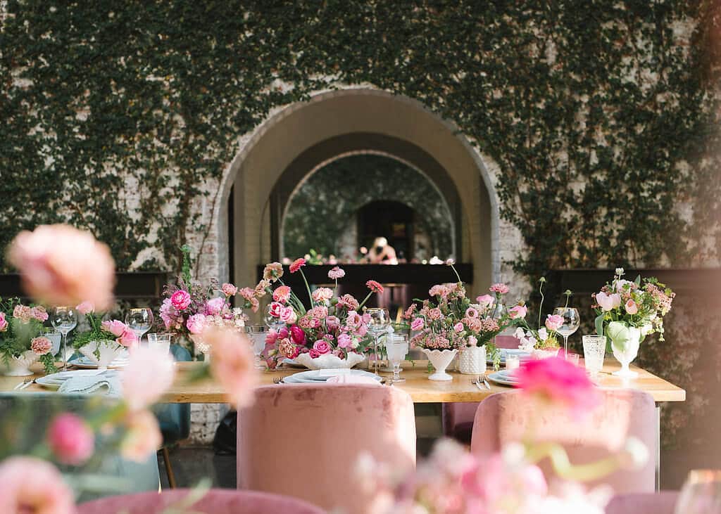 Beautiful dinner table set for an evening gathering at a lush greenhouse in New York City.